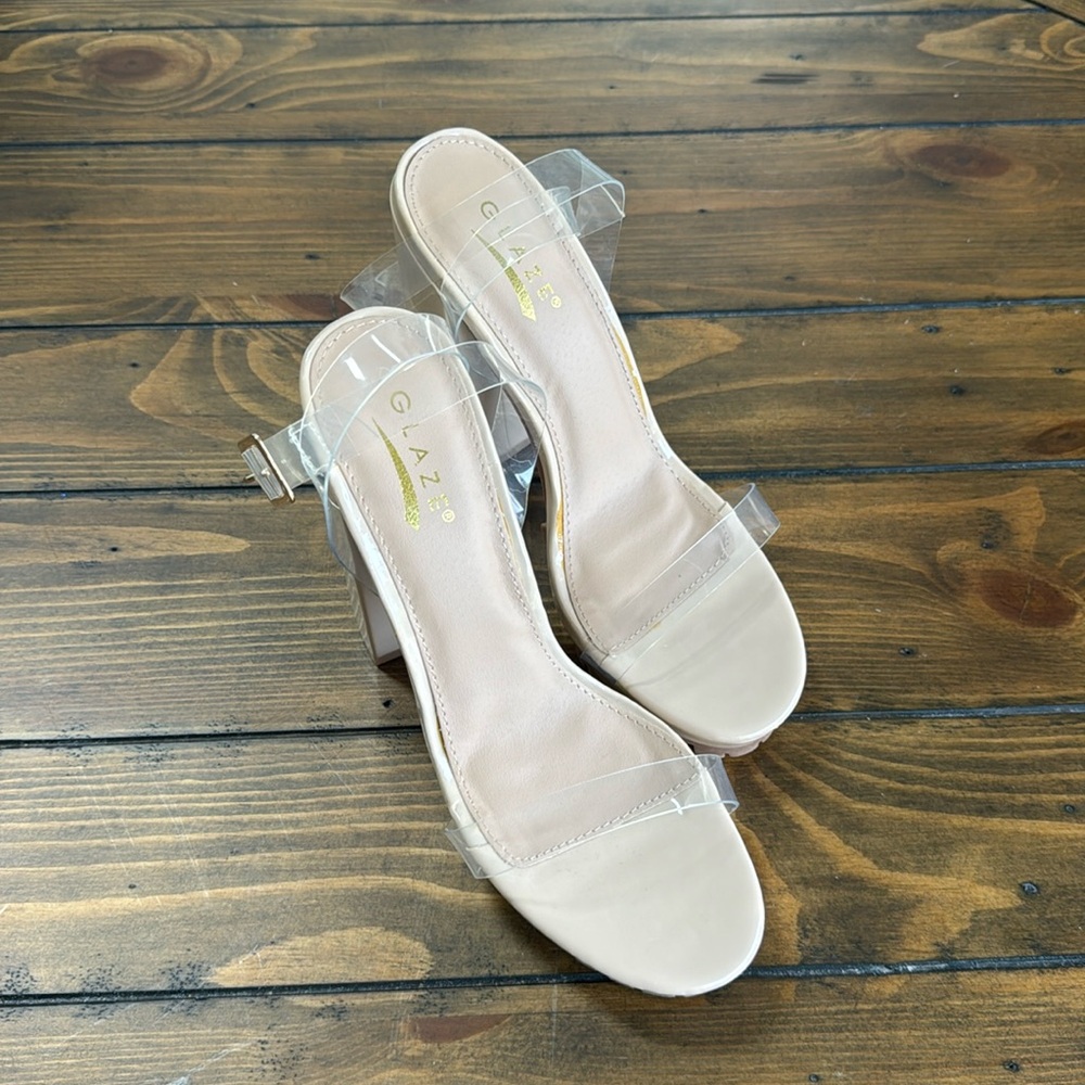 Brand new, never worn nude heel, clear straps and rubber sole.